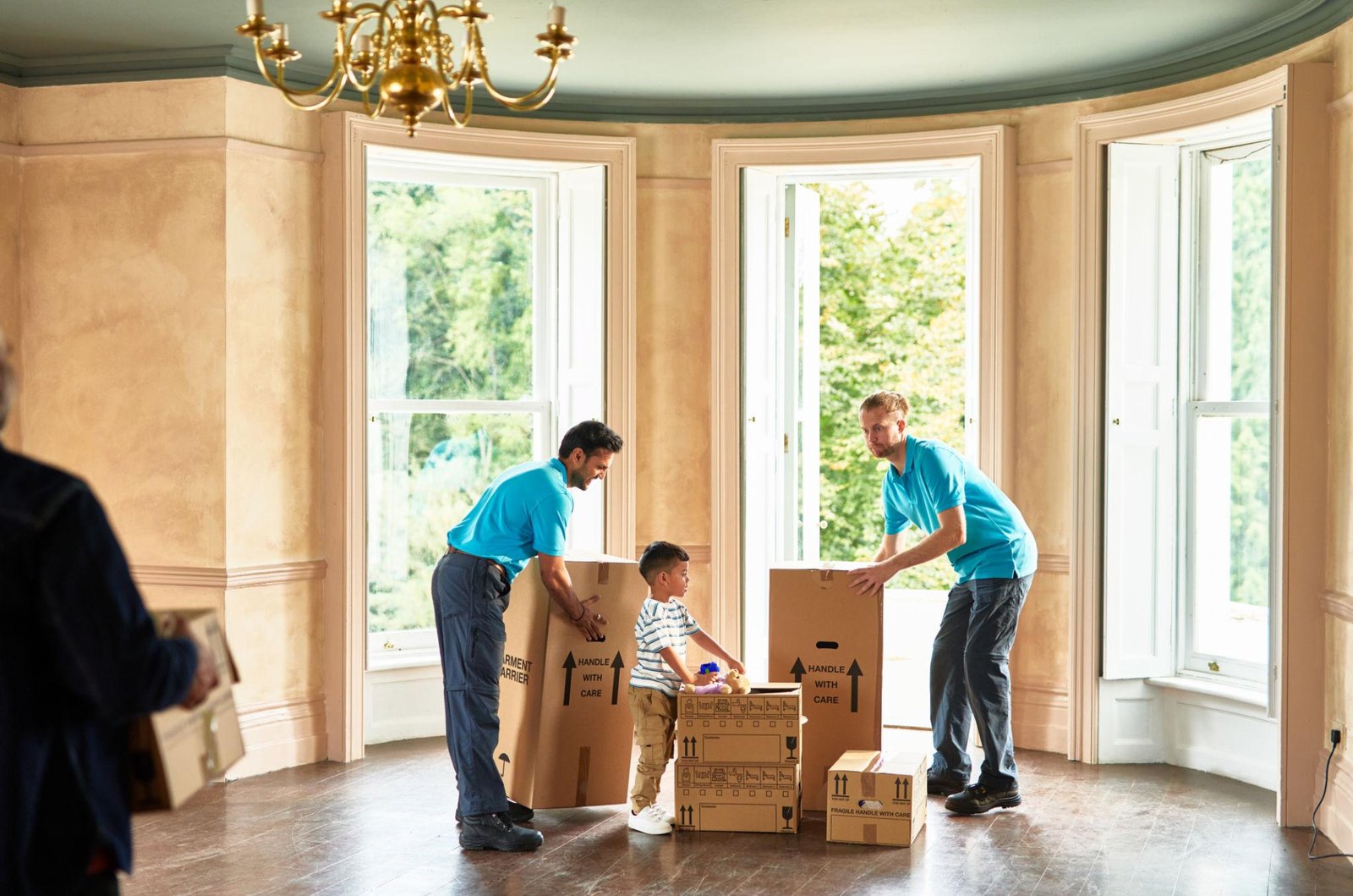 Removal team moving furniture in a home
